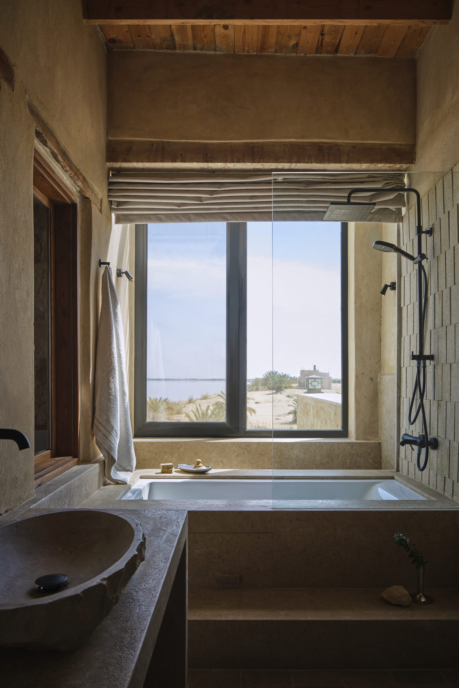 Stone bath with a window onto the lake